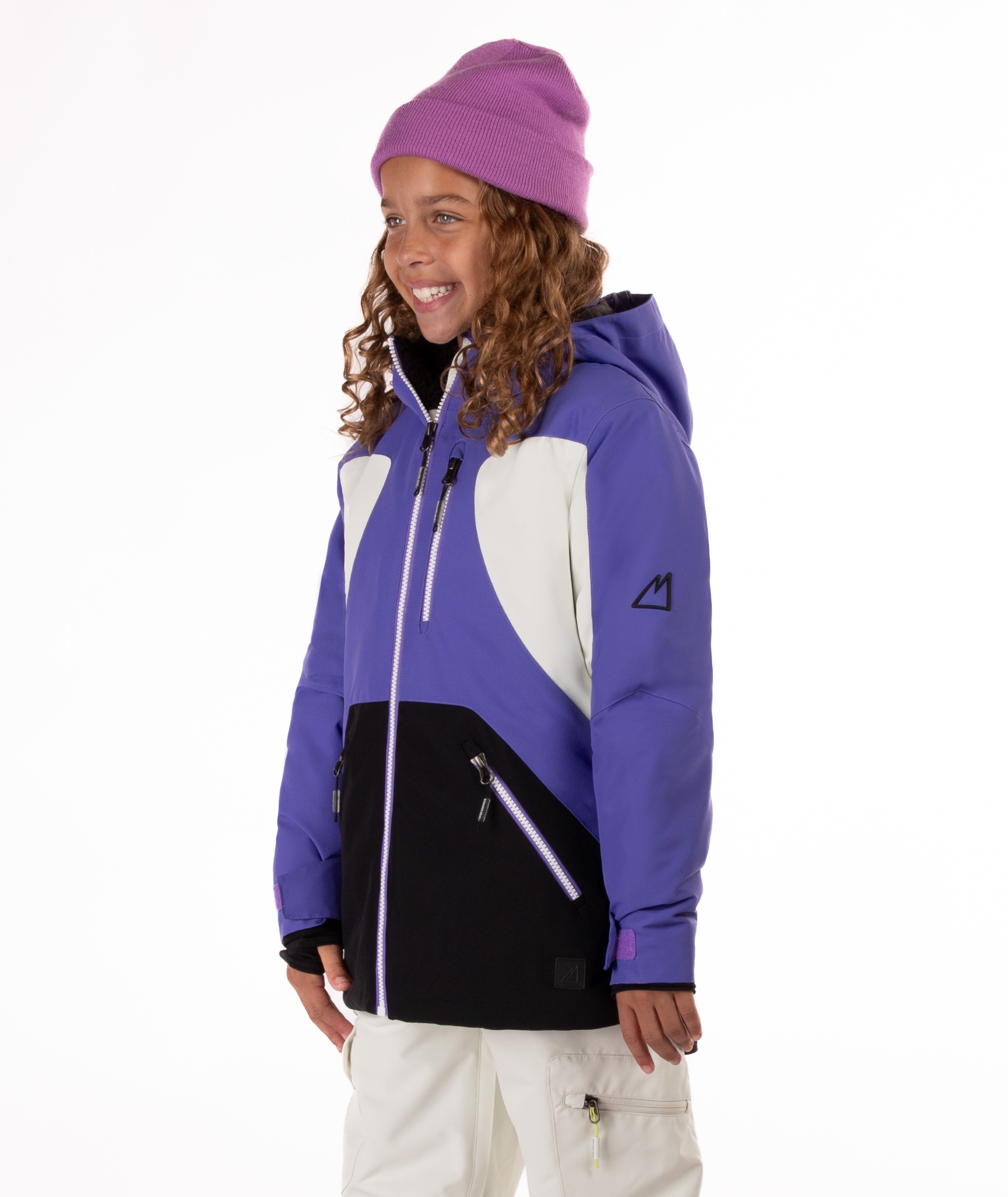 Child wearing a colorful a purple, white, and black jacket with a white background