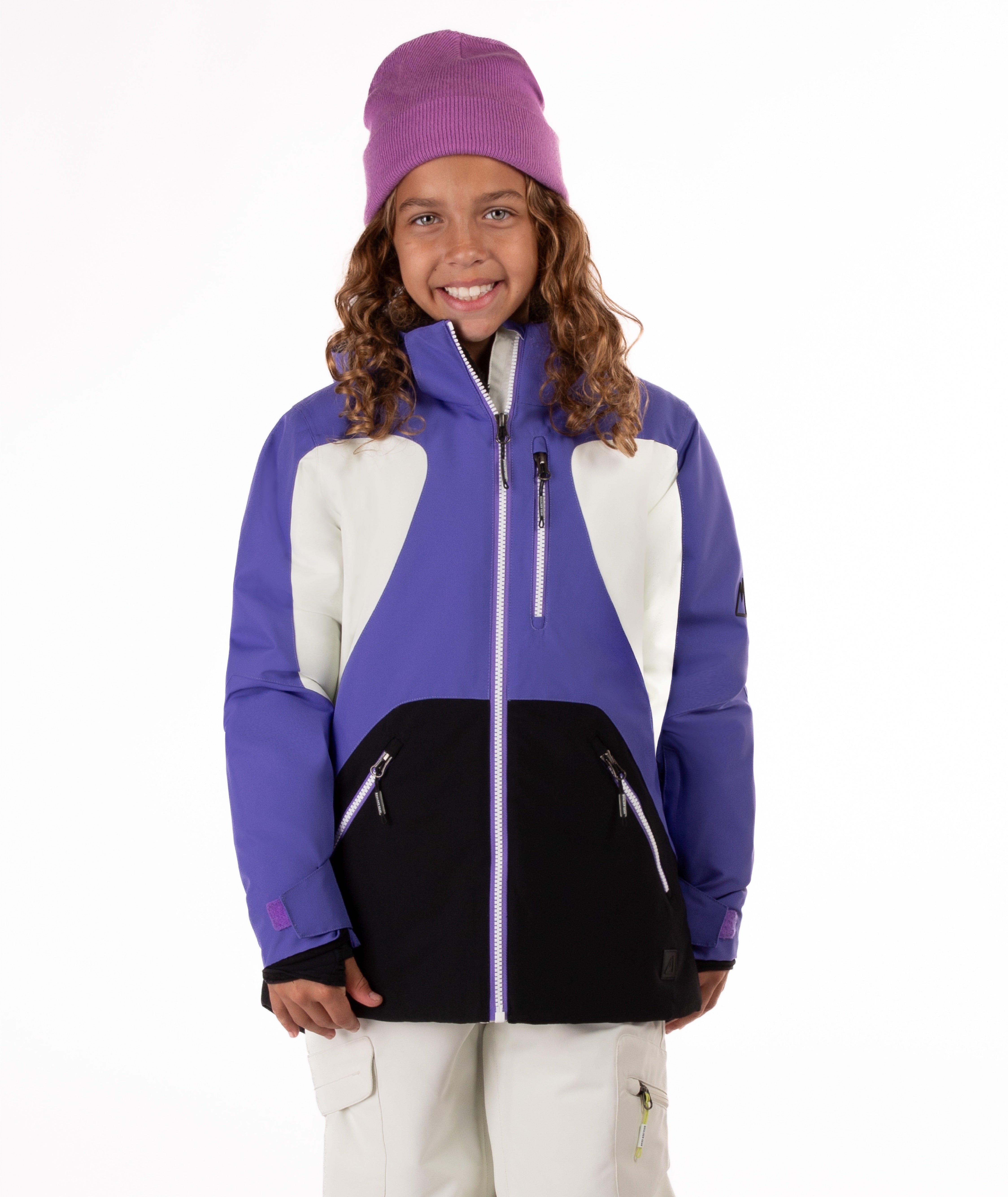 Child wearing a colorful a purple, white, and black jacket with a white background