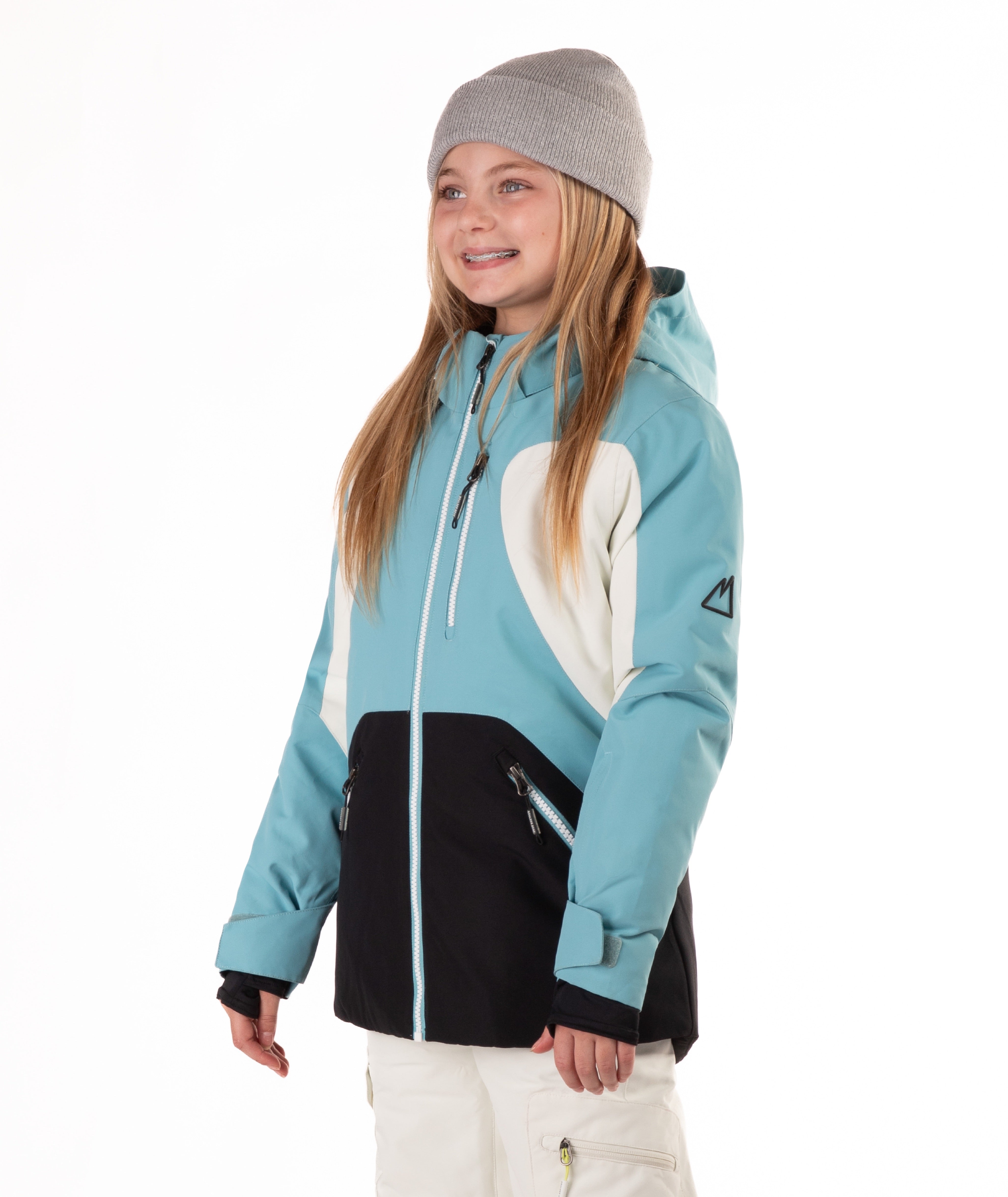 Youth Girl wearing a blue, white and black jacket with a white background