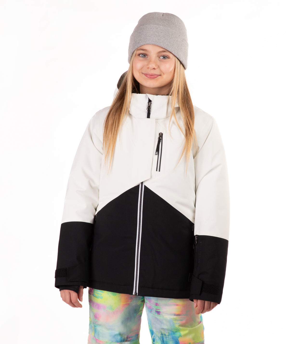 Child wearing a white and black jacket with colorful pants on a white background