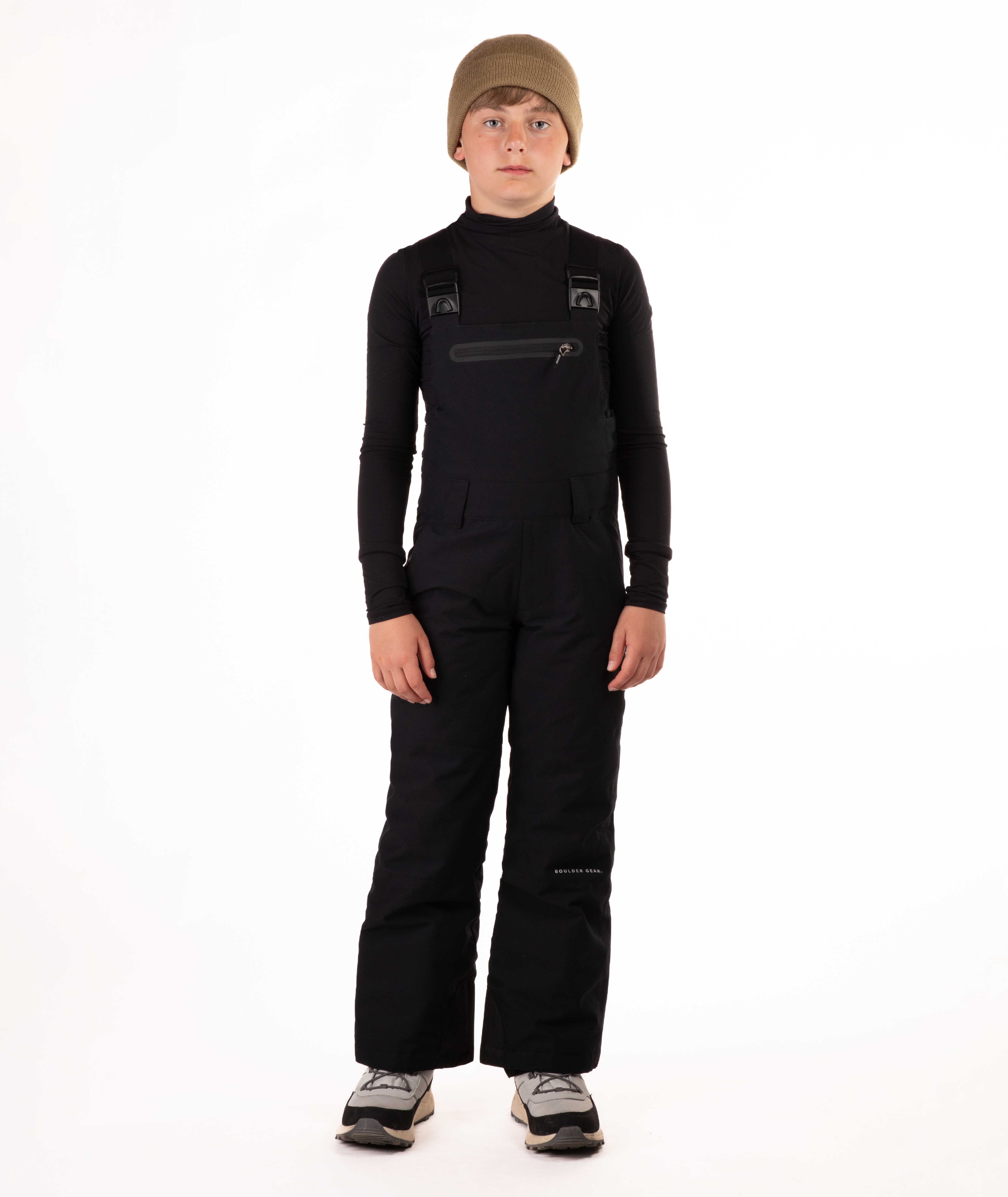 boy wearing black bibs and black top on a white background
