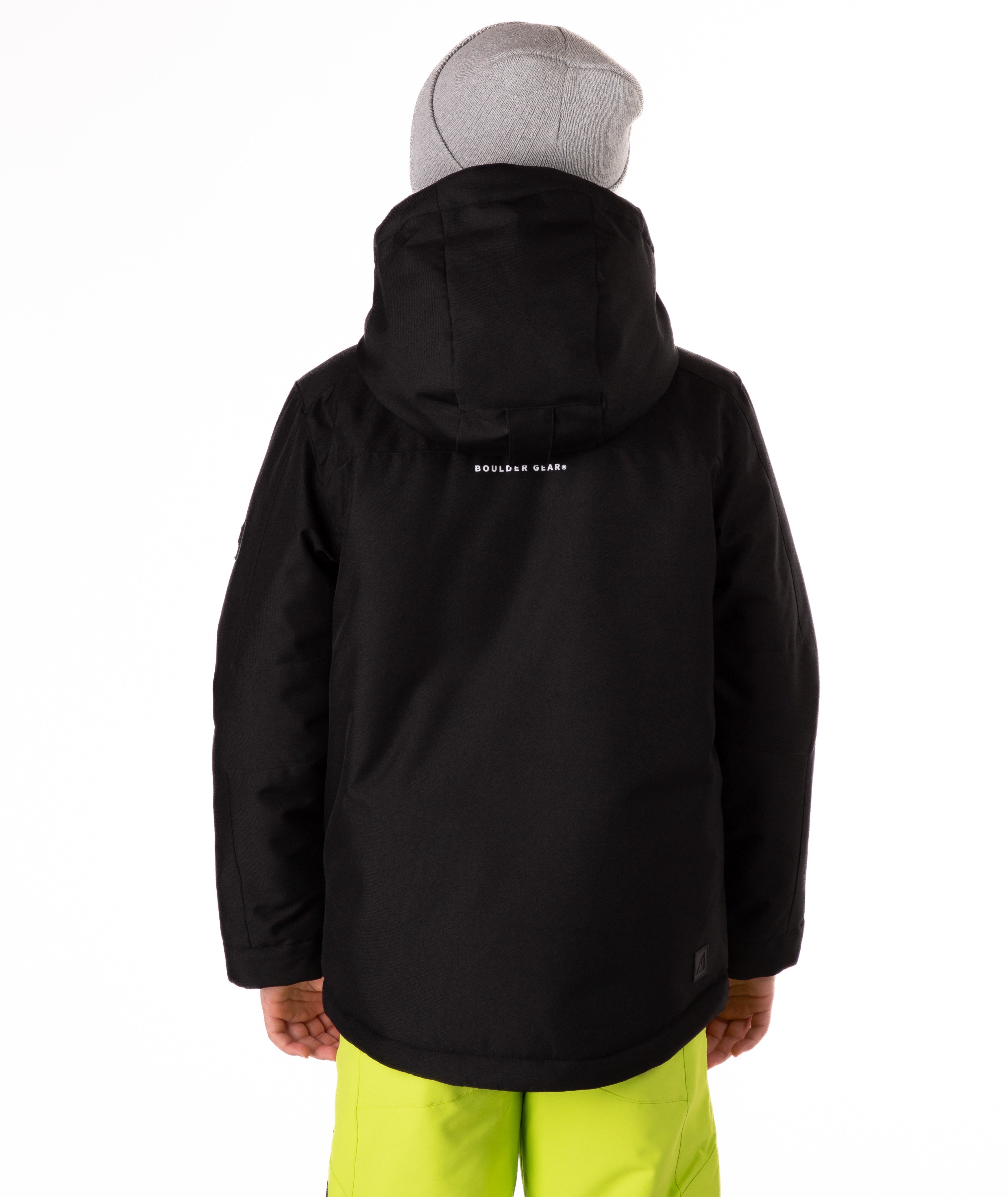 Youth boy wearing a black jacket standing against a white background