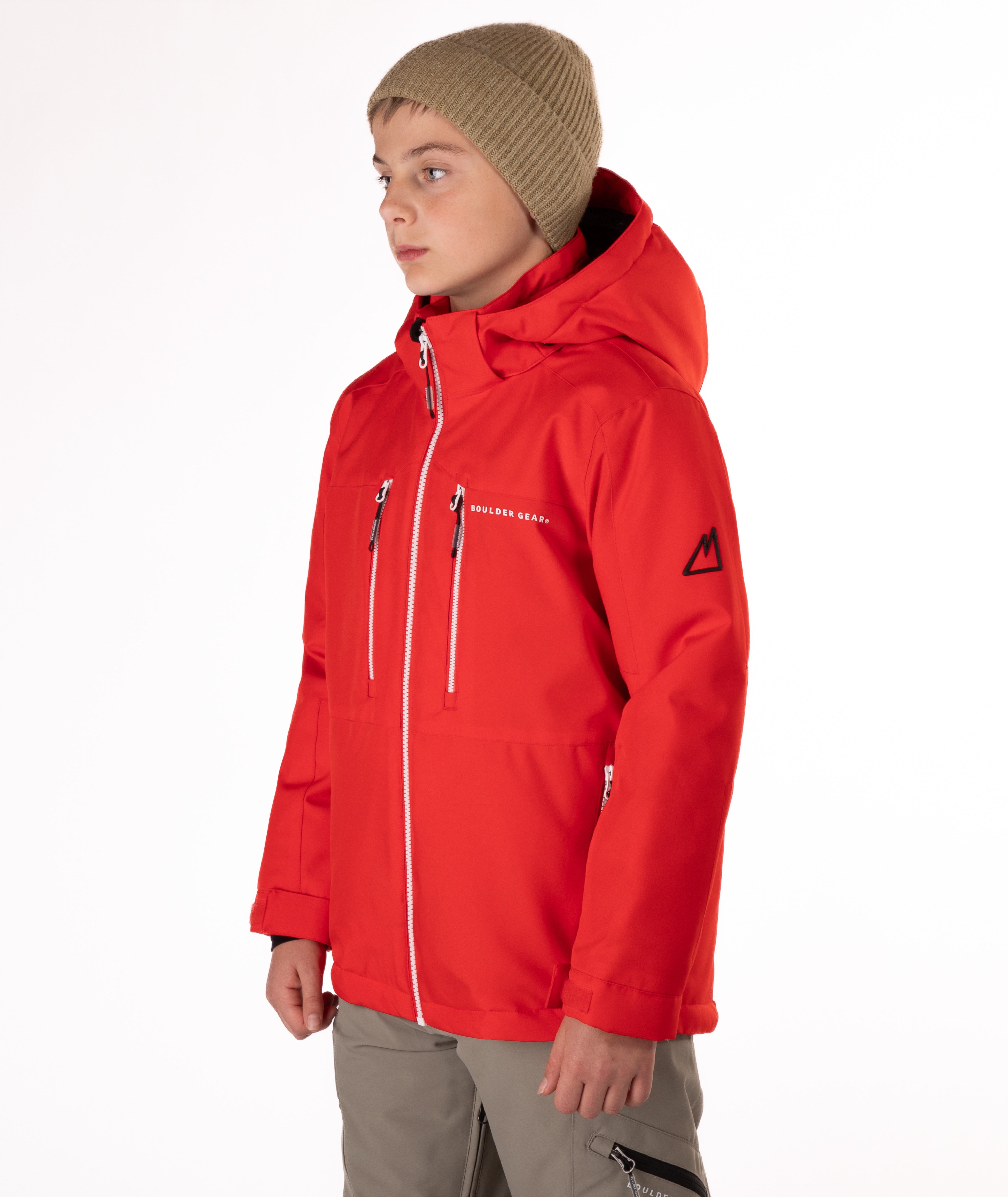 Youth boy wearing a red jacket with white zippers and a Boulder Gear brand logo on a white background