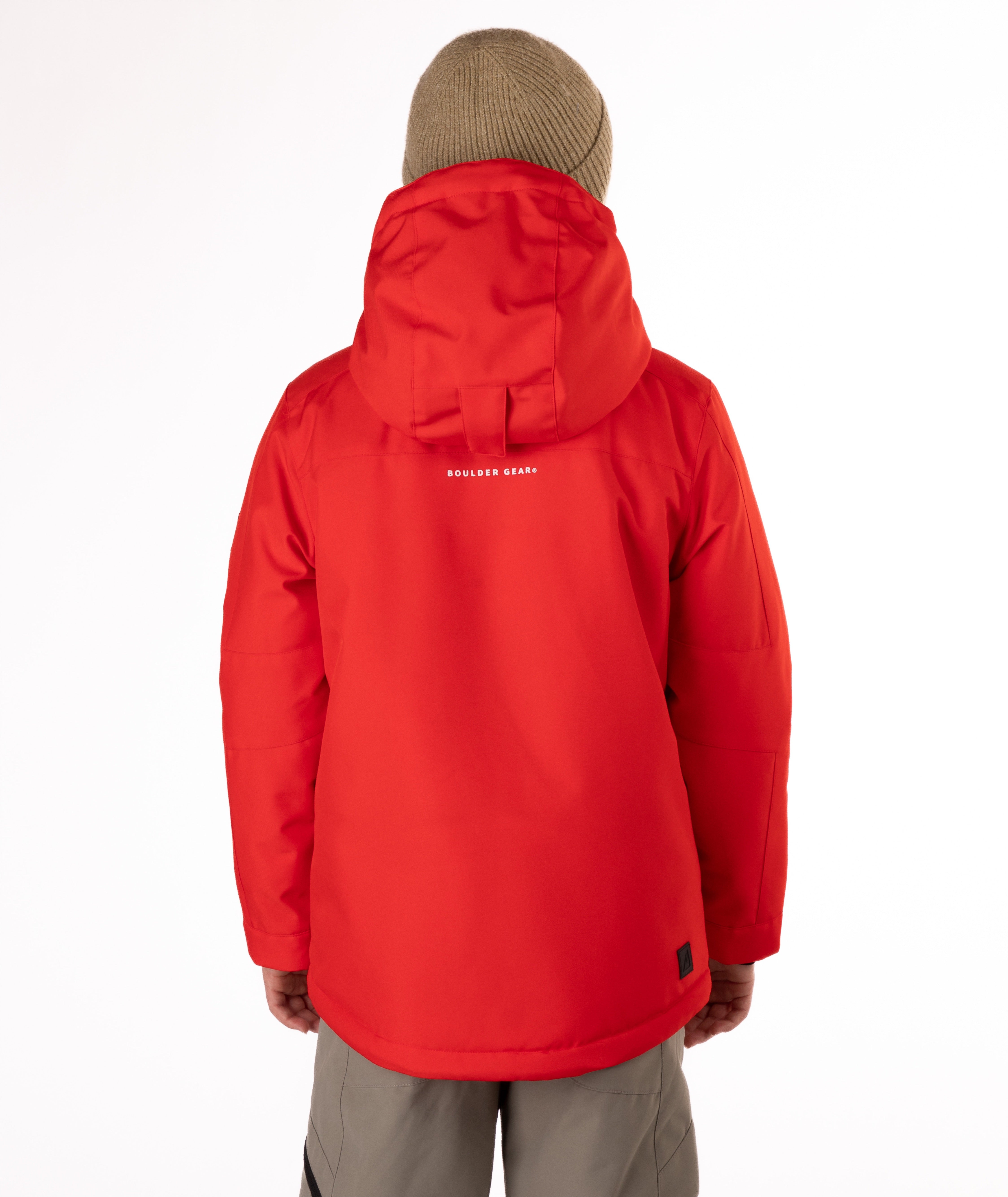 Youth boy wearing a red jacket with a brand logo on the back, standing against a white background