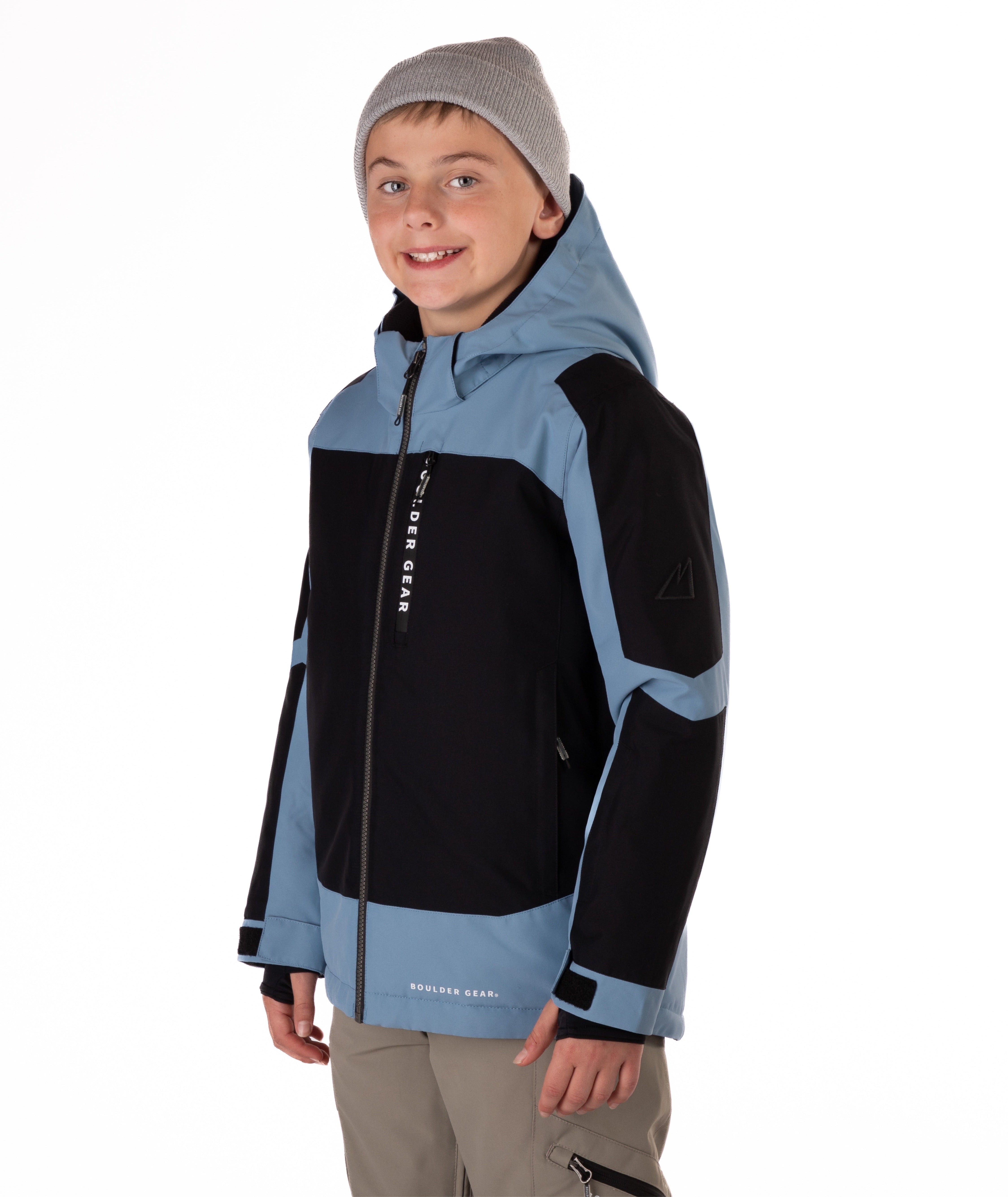 Child wearing a black and blue jacket with a hood on a white background