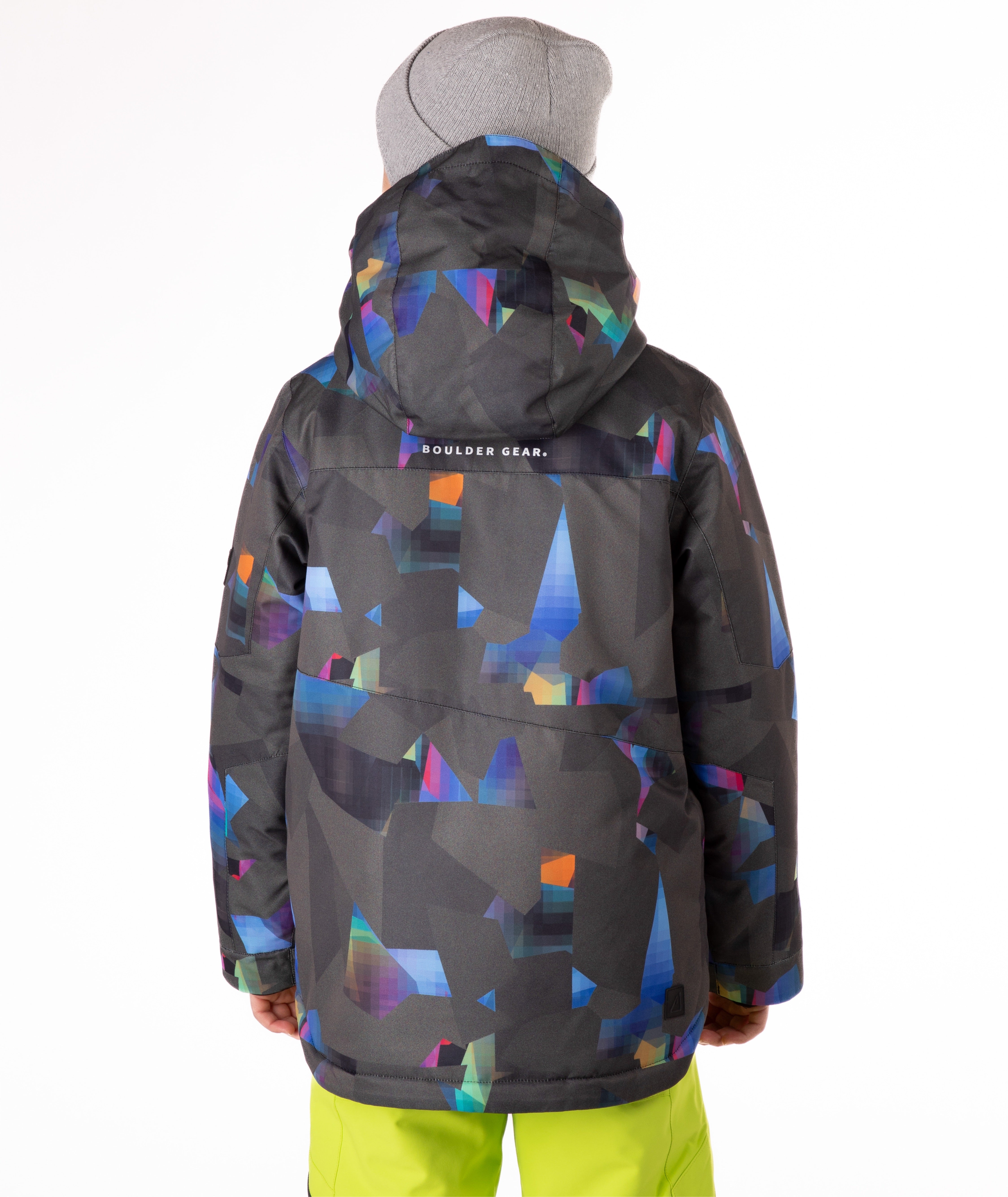 Youth boy wearing a colorful jacket with abstract patterns on a white background