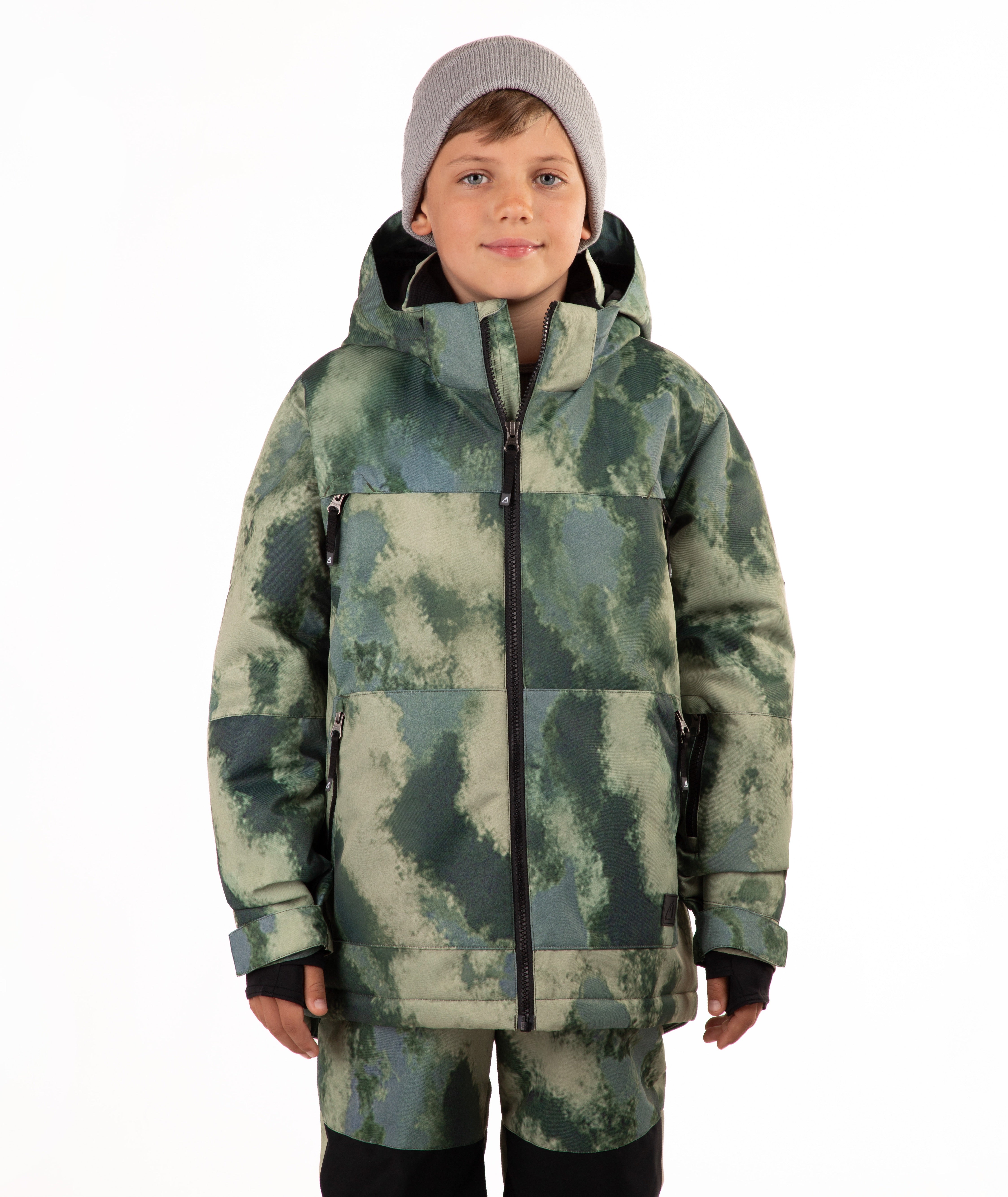 A child wearing a camouflage-patterned ski jacket and matching pants with a gray beanie, standing against a plain white background.