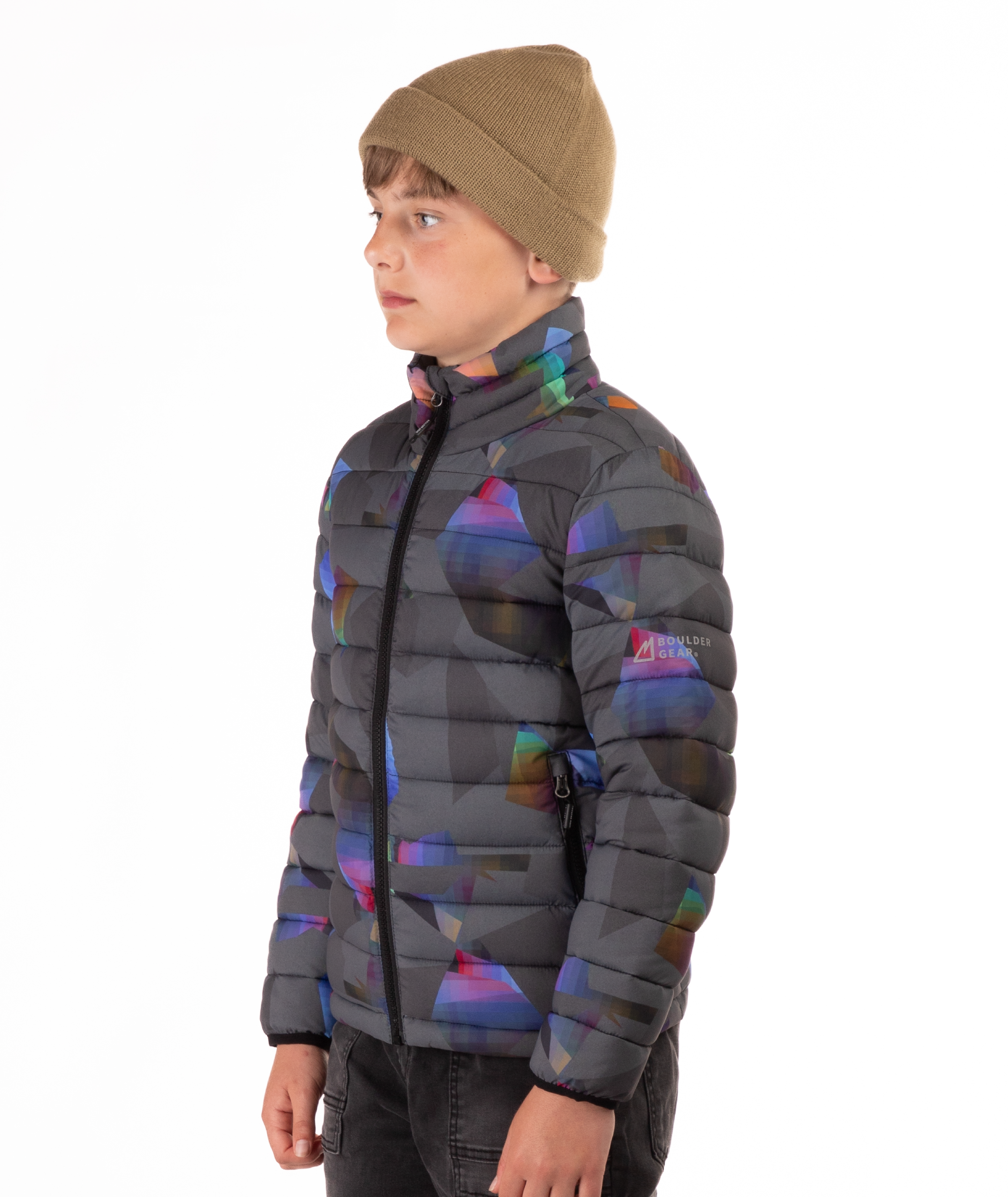 youth boy wearing a multi colored abstract patterned puffer jacket on a white background