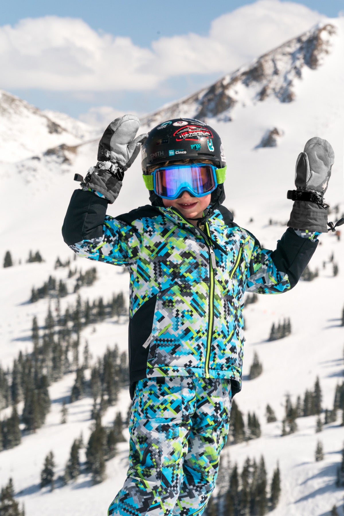 kid on mountain wearing a digital camouflage printed jacket