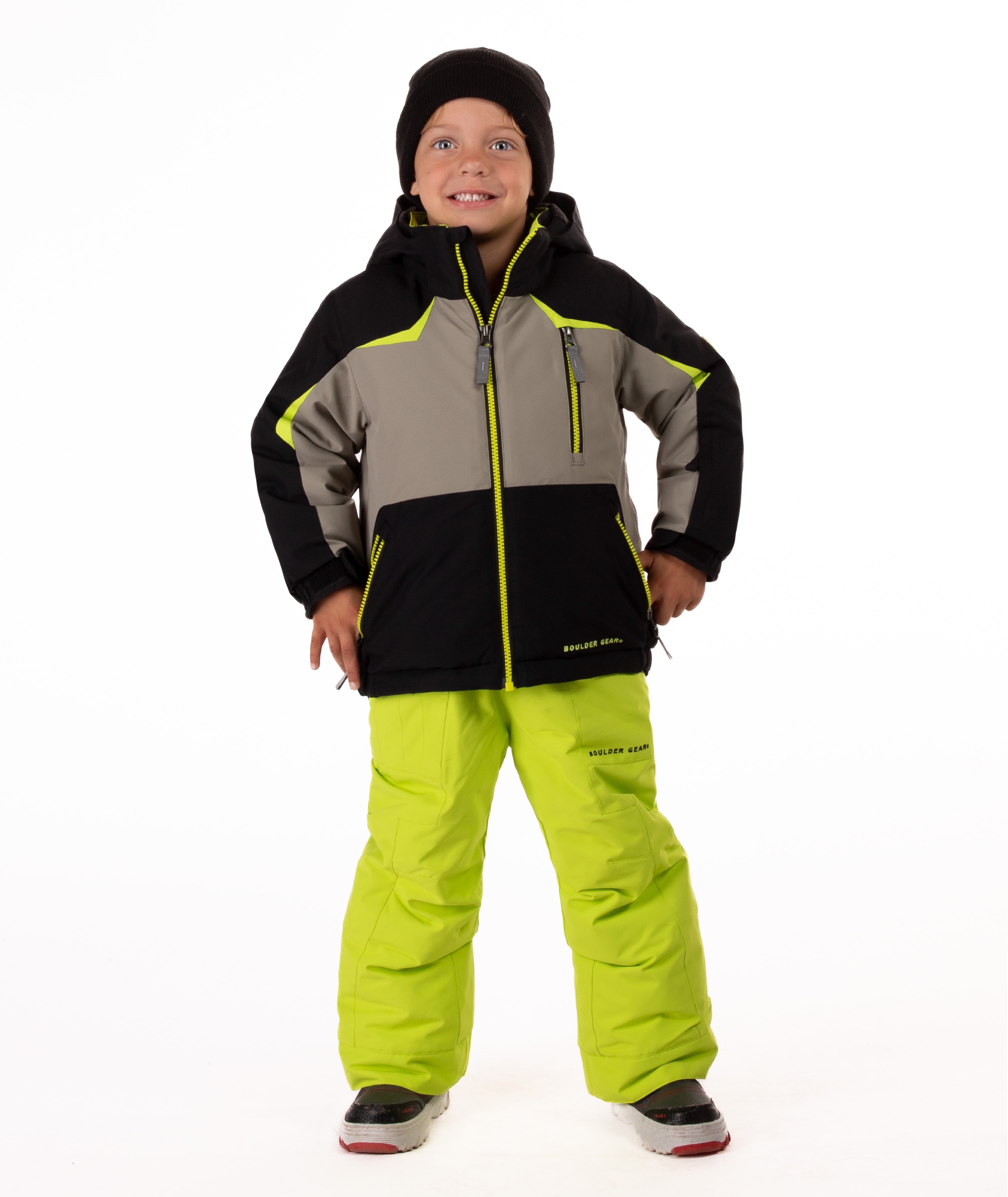 Child wearing an black and grey insulated winter jacket with bright lime trim and a lime center front zipper 
