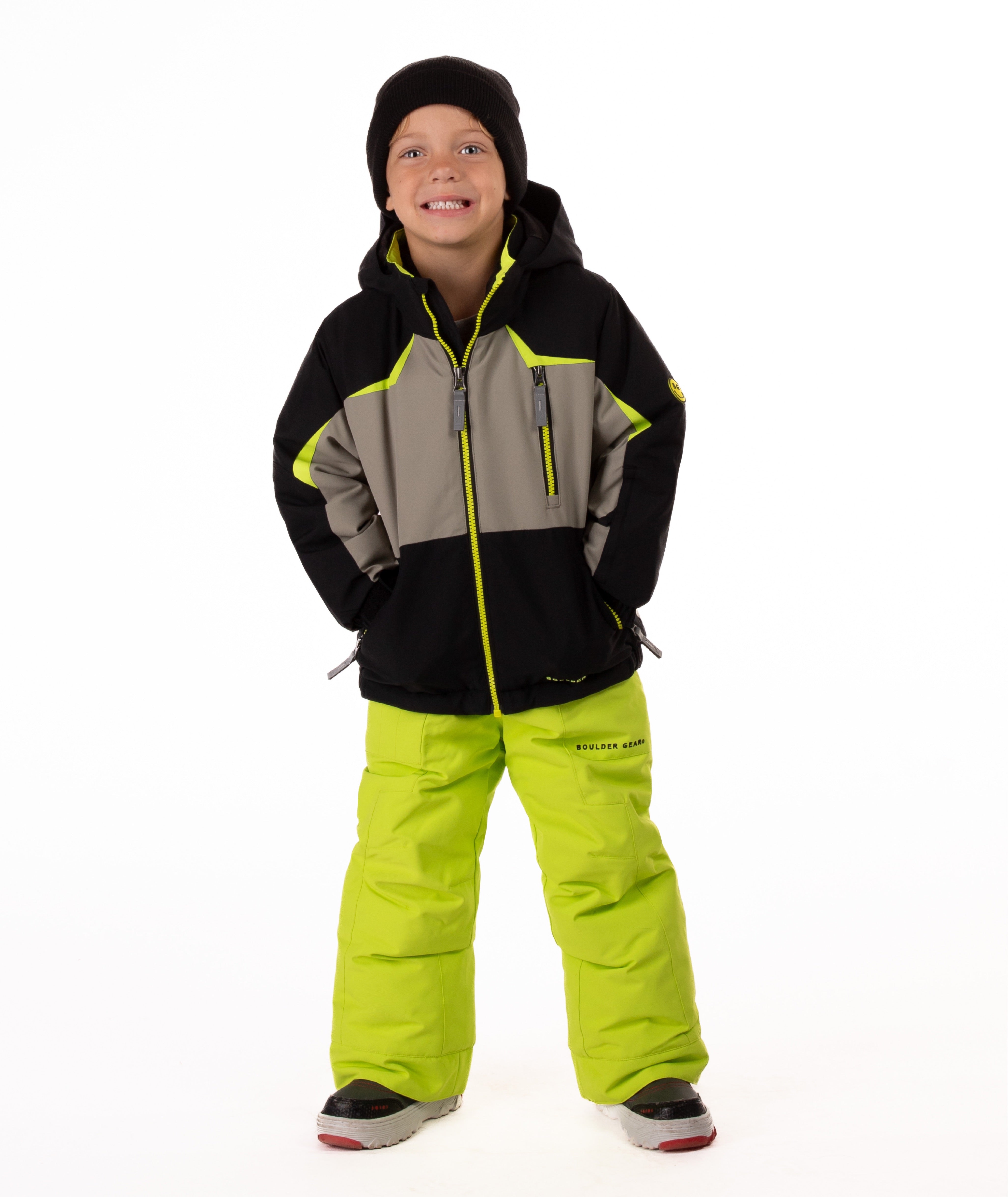 Child wearing an black and grey insulated winter jacket with bright lime trim and a lime center front zipper 