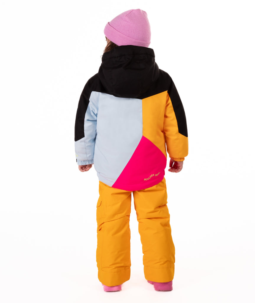 Child wearing a colorful jacket geometric designed winter jacket with light blue, bright pink, orange, and black on a white background. 