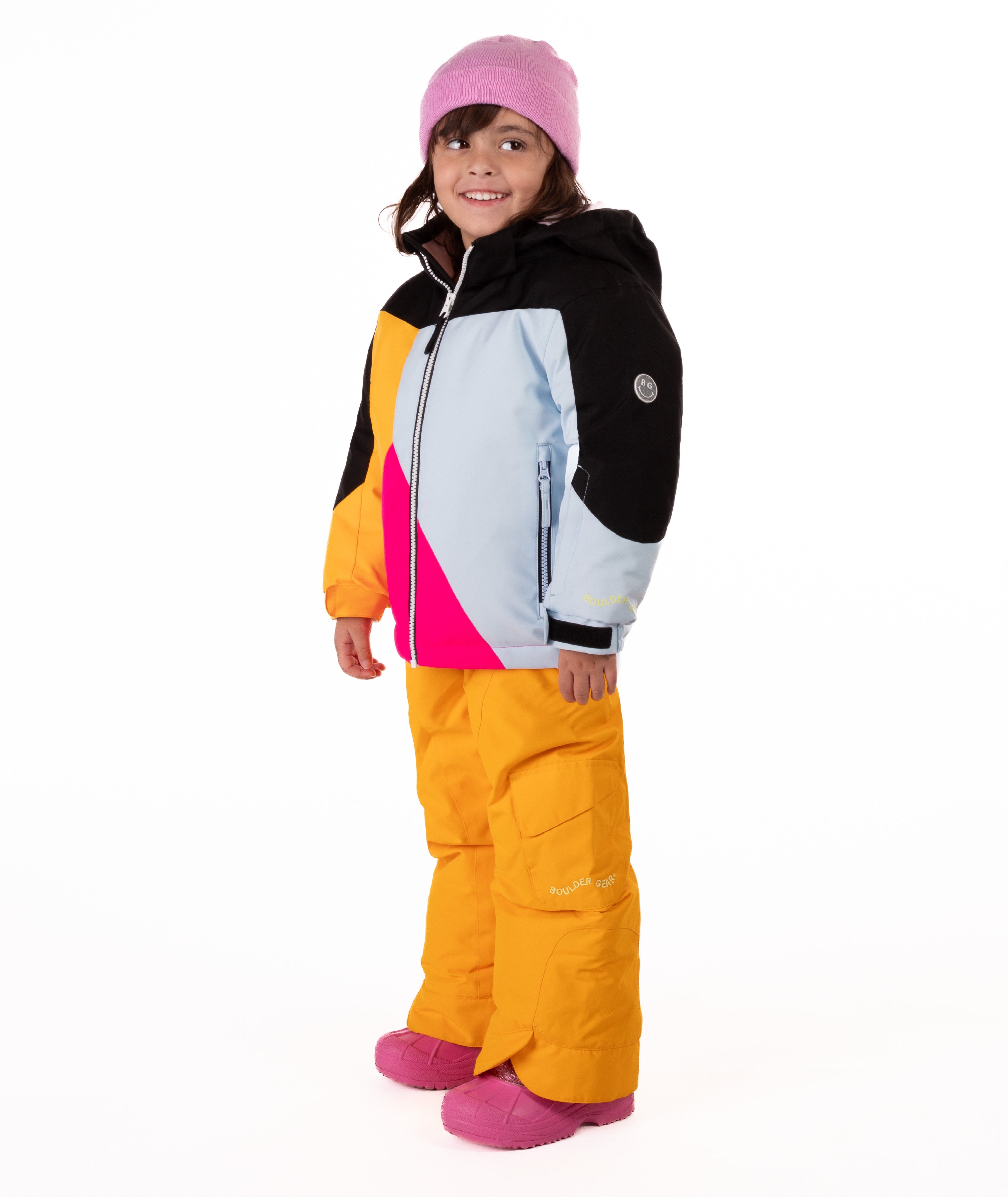 Child wearing a colorful jacket geometric designed winter jacket with light blue, bright pink, orange, and black on a white background. 