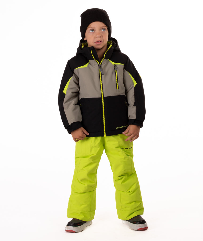 Child wearing an black and grey insulated winter jacket with bright lime trim 
