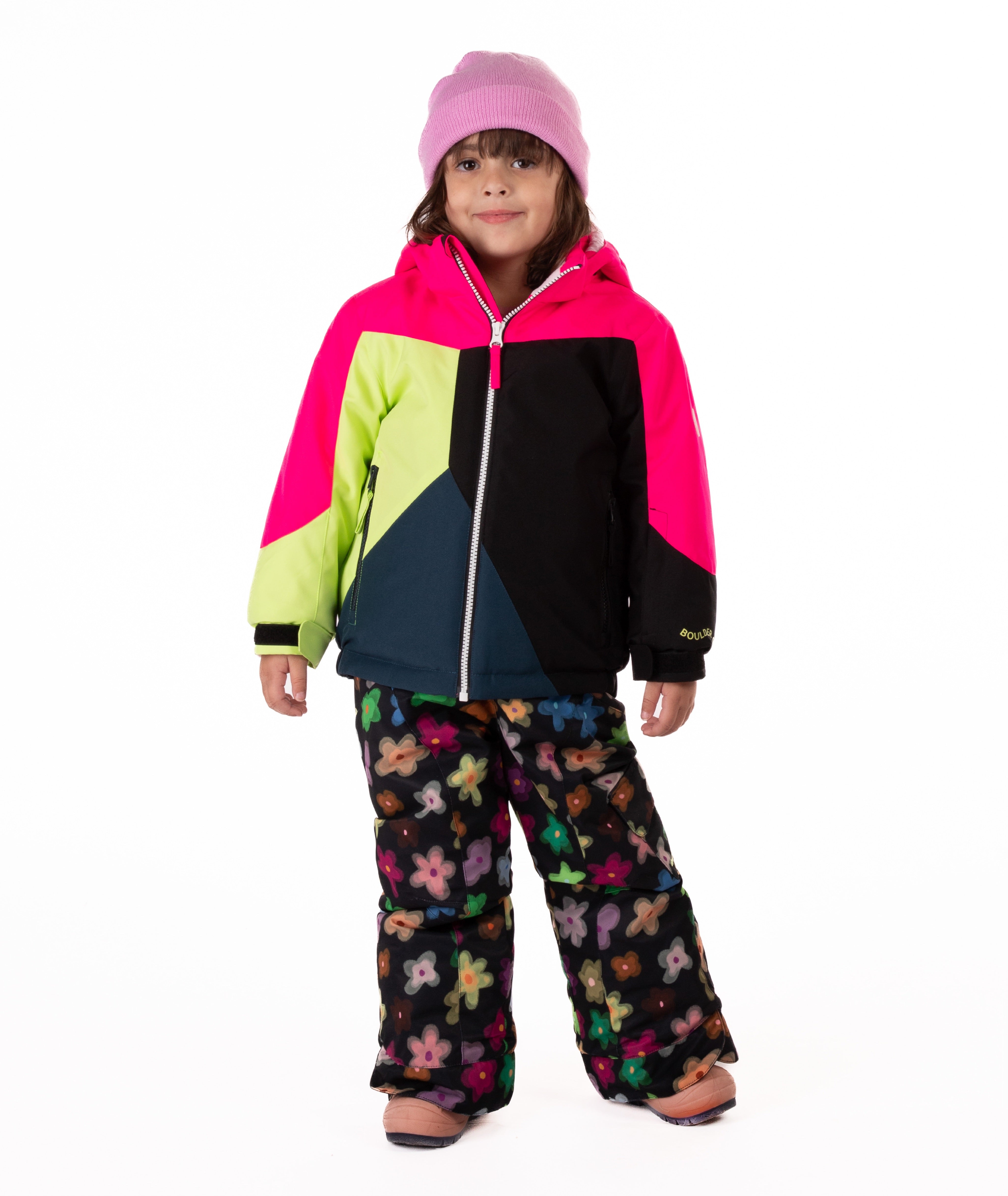 Child wearing a colorful jacket with bright pink, green, black, and navy colors on a  white background
