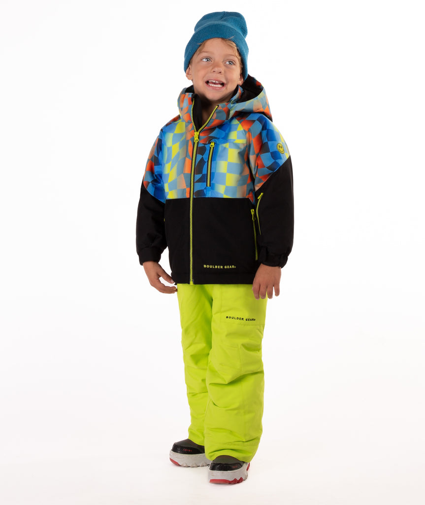 Child wearing a two-tone jacket with a geometric multi-color print on the top and black on the bottom of the jacket