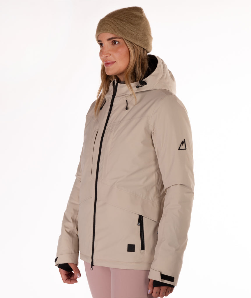 Woman wearing a beige winter jacket with hood on a white background