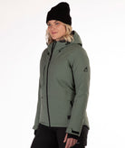 Woman wearing a green winter jacket on a white background