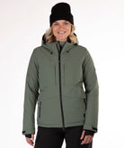 Woman wearing a green winter jacket on a white background