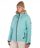 Woman wearing a light blue winter jacket on a white background