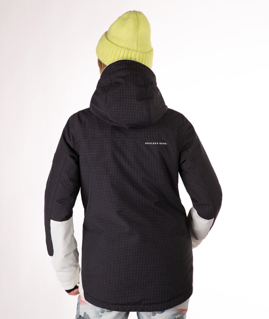 Person wearing a black checked hooded jacket with a visible brand logo on back hip of jacket on a white background