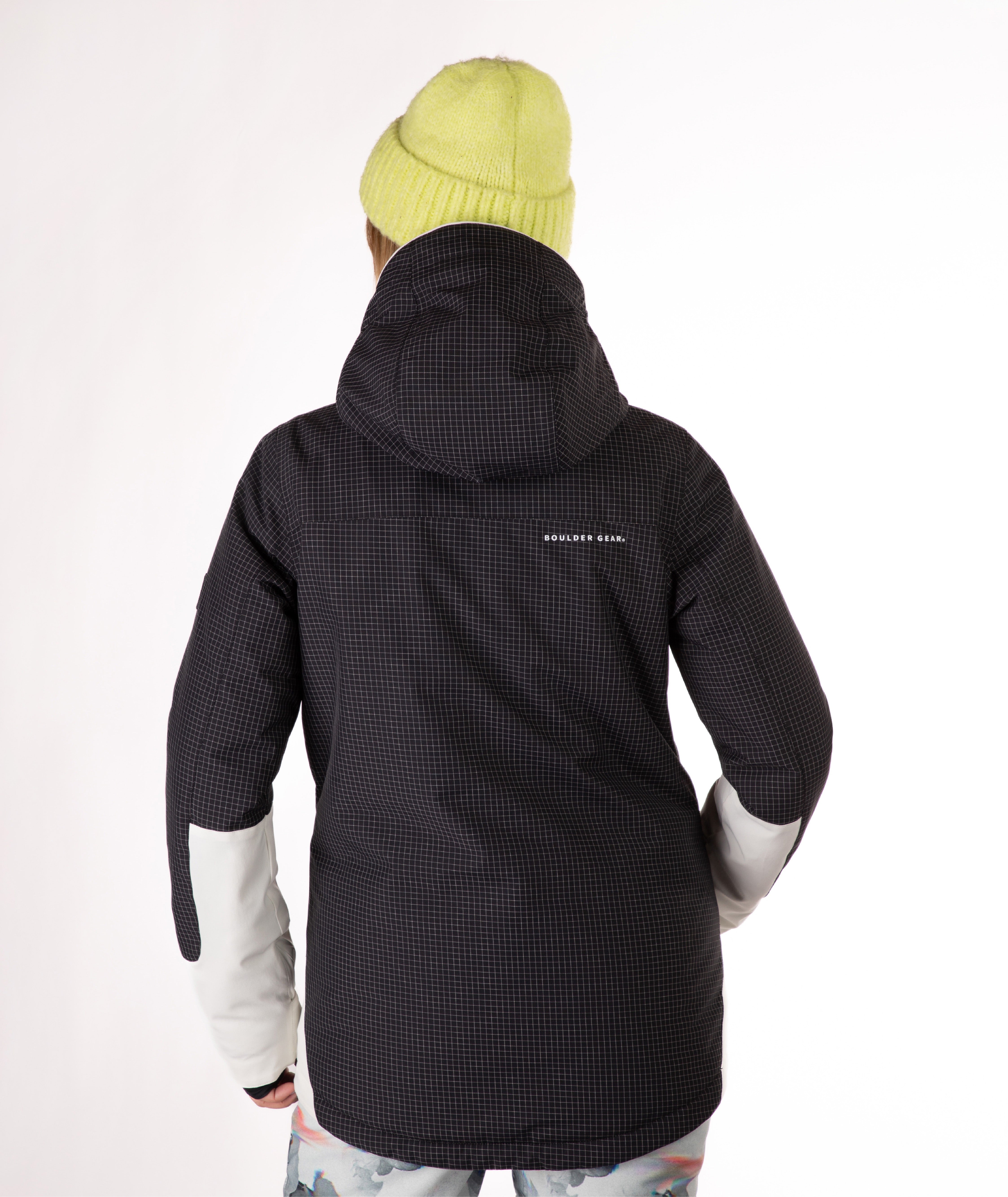 back of Person wearing a two-tone black and white jacket a white background