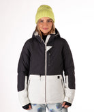 Person wearing a two-tone black and white jacket a white background