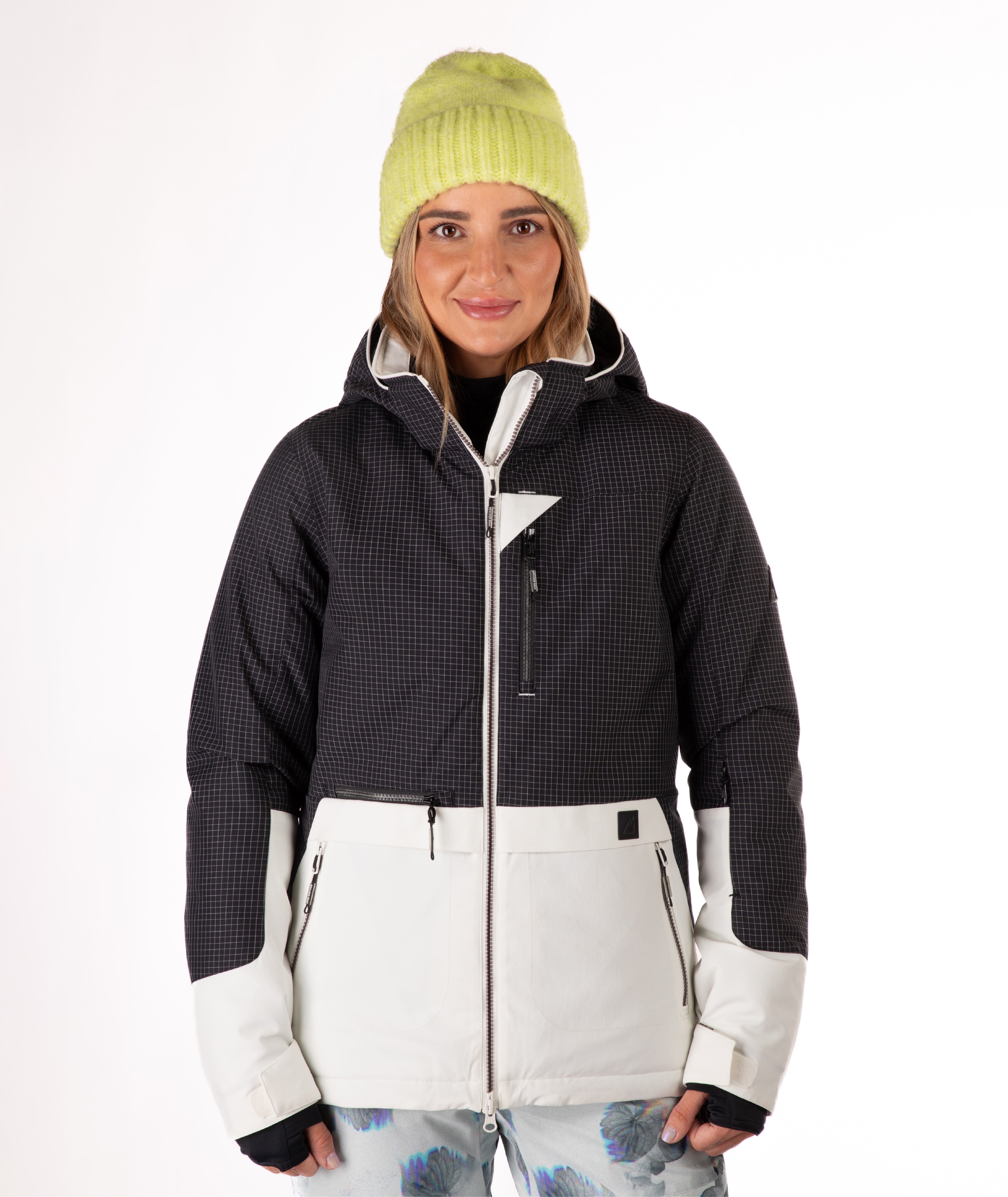 Person wearing a two-tone black and white jacket a white background