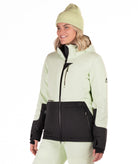 Woman wearing a two-tone light green and black checked jacket with a white background