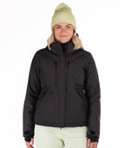 Person wearing a black checkered snow jacket on a white background