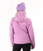 A woman wearing a light purple/lavender ski jacket and a matching knit beanie against a plain white studio background.