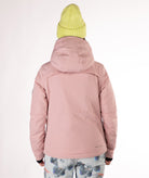 Woman wearing a pink jacket with black chest zippers on a white background highlighting back of jacket and hood