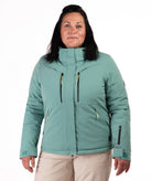 Woman wearing a teal snow jacket with black chest zippers on a white background