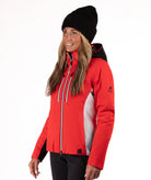 Woman wearing a red and black ski jacket on a white background