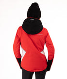 Woman wearing a red and black ski jacket on a white background showing back view of jacket