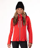 Woman wearing a red and black ski jacket on a white background