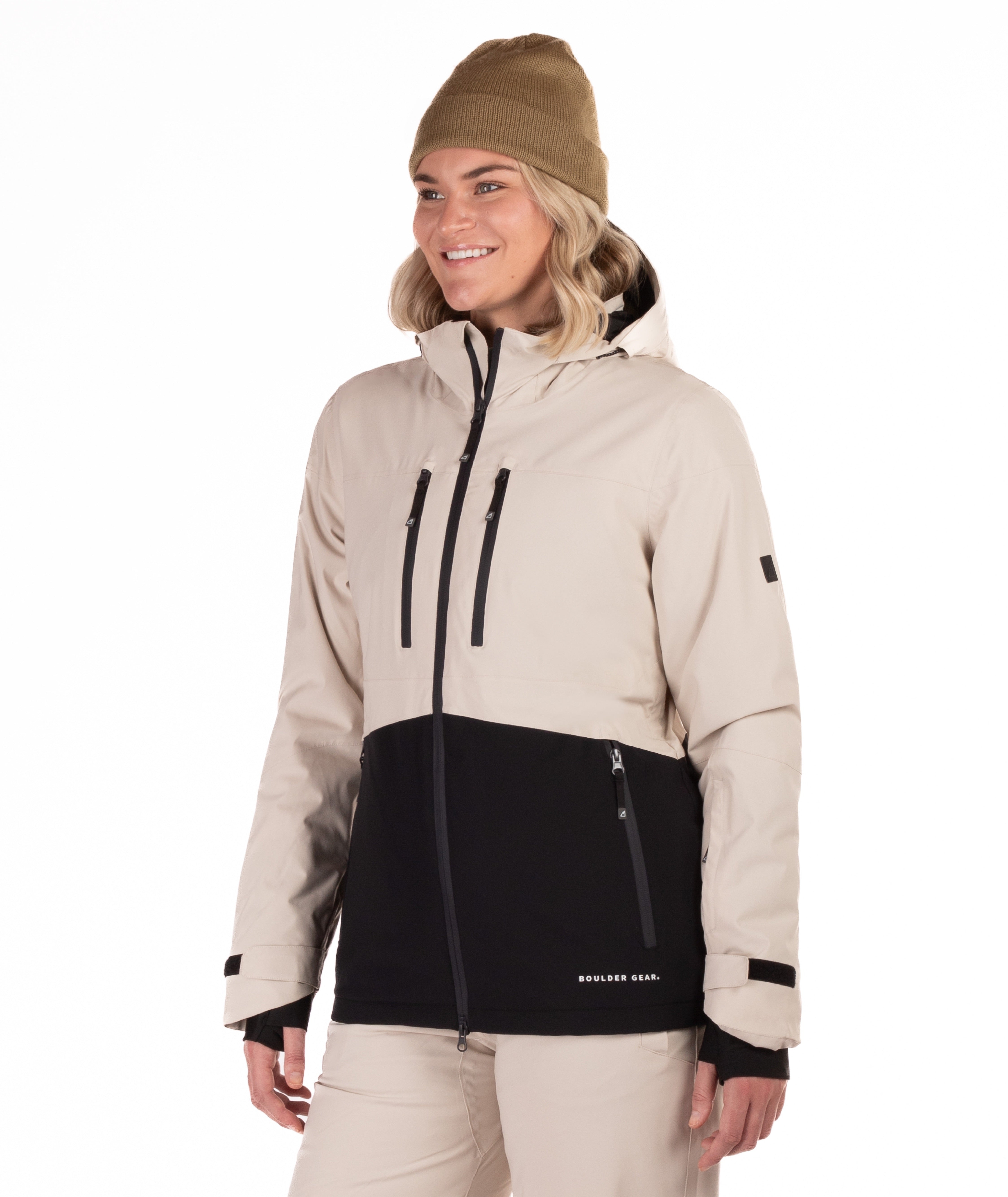 Woman wearing a beige and black jacket with a white background