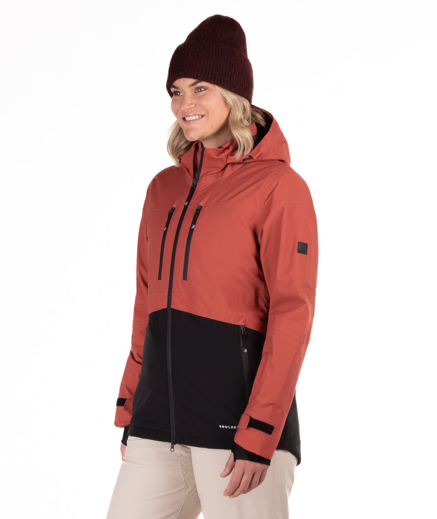 Woman wearing a red and black jacket with a white background