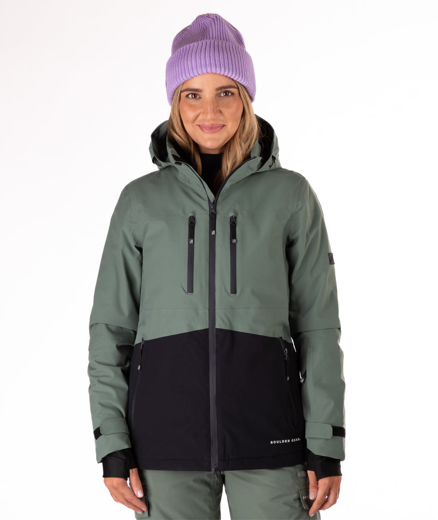 Person wearing a green and black jacket on a white background