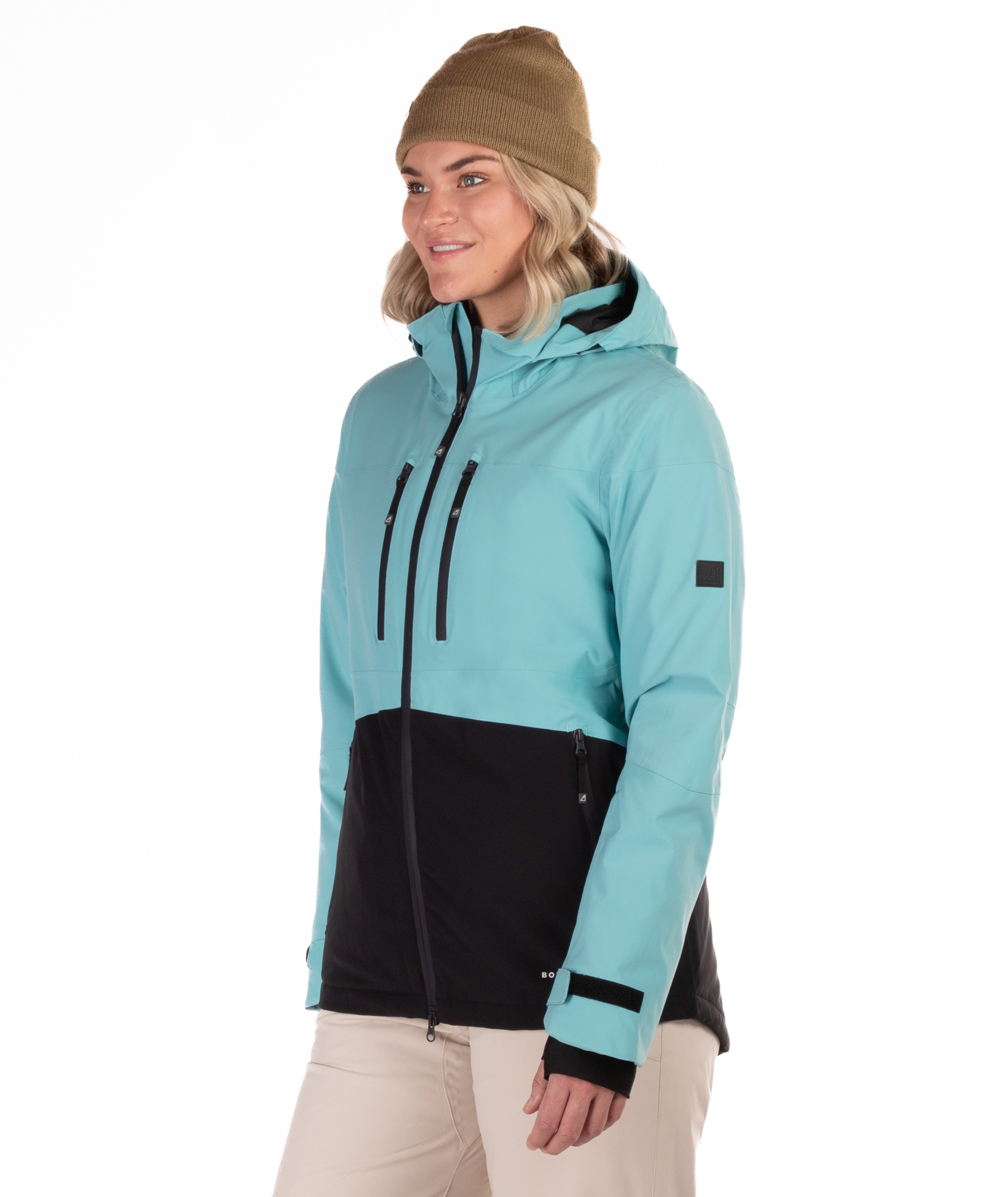 Woman wearing a light blue and black jacket on a white background