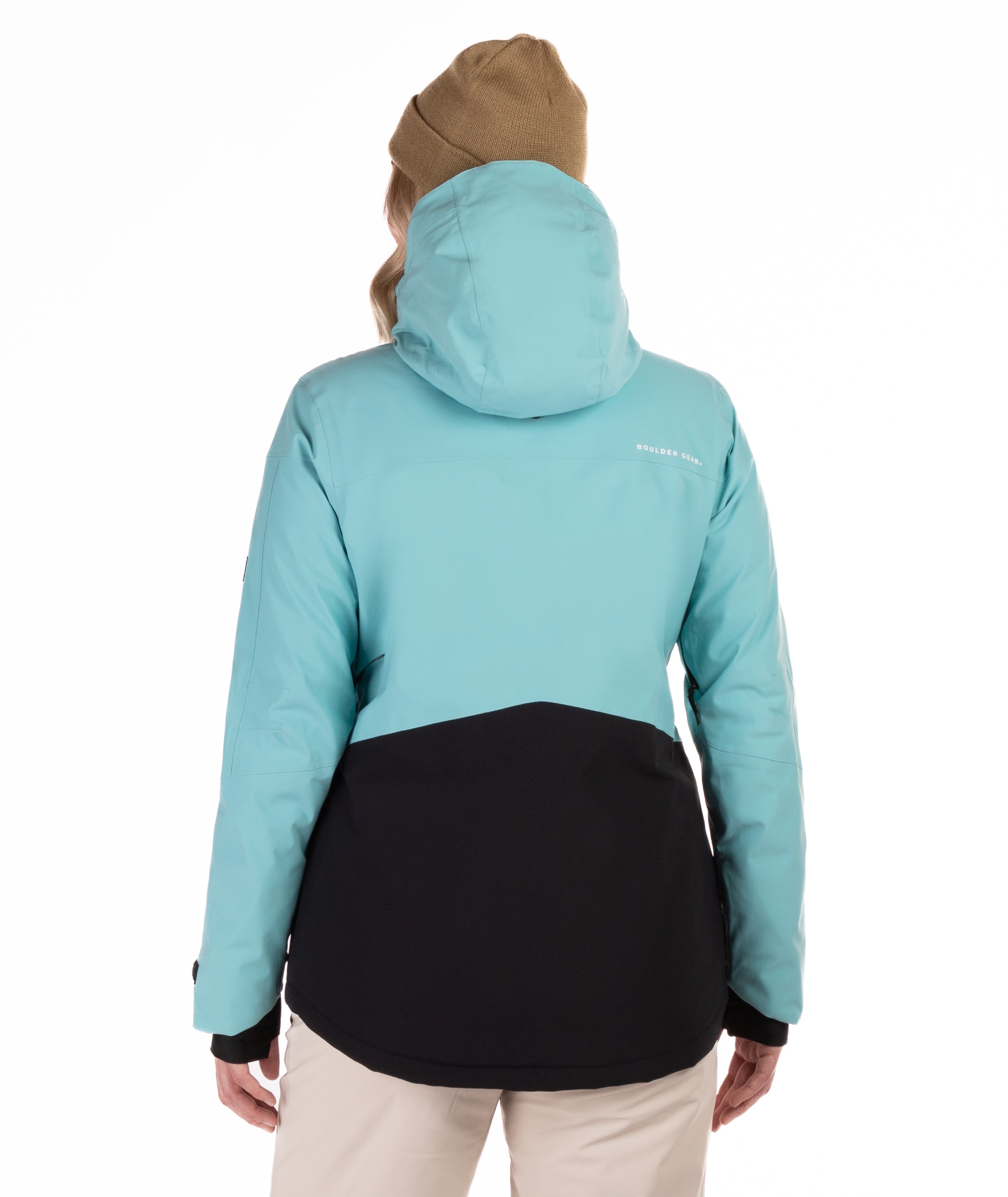 Person wearing a two-tone jacket with light blue upper half and black lower half on a white background