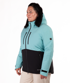 Woman wearing a light blue and black jacket on a white background