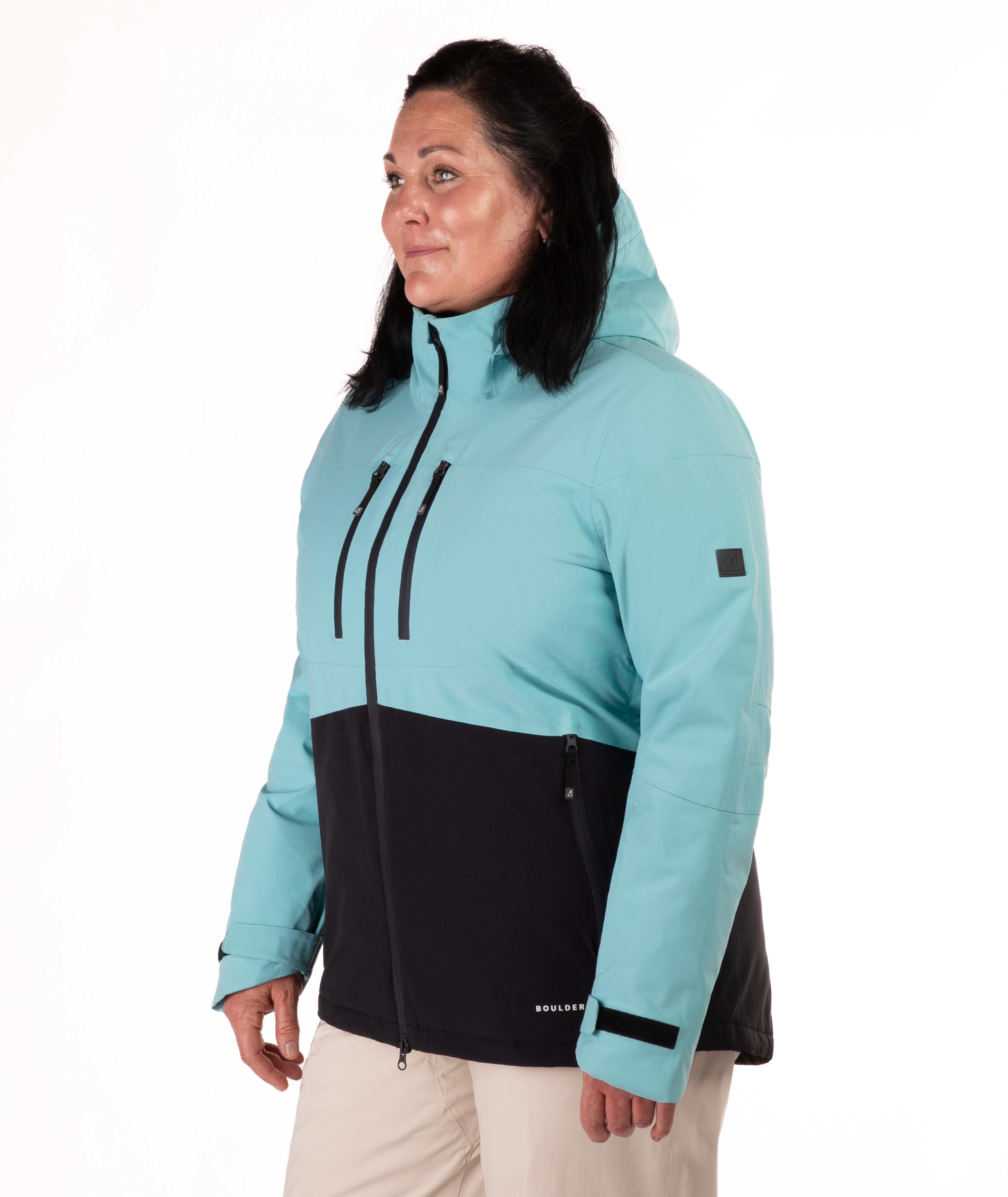 Woman wearing a light blue and black jacket on a white background