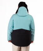 Person wearing a two-tone jacket with light blue hood and black lower half on a white background