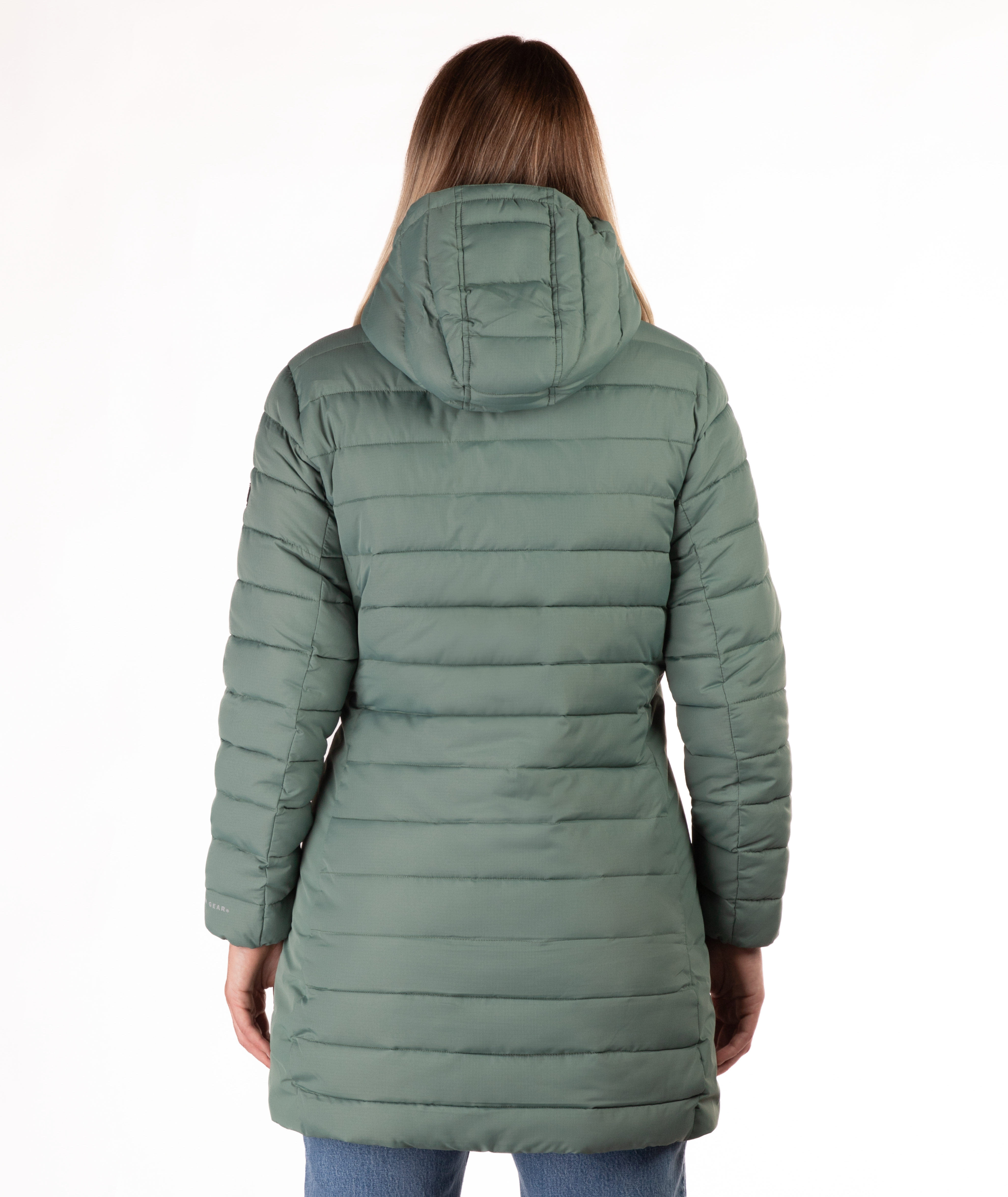 Woman wearing a green mid thigh length puffer coat on a white background