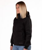 Woman wearing a black jacket with a hood  highlighting the sleeve detail on a white background