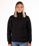 Woman wearing a black jacket with a visible brand logo on a white background