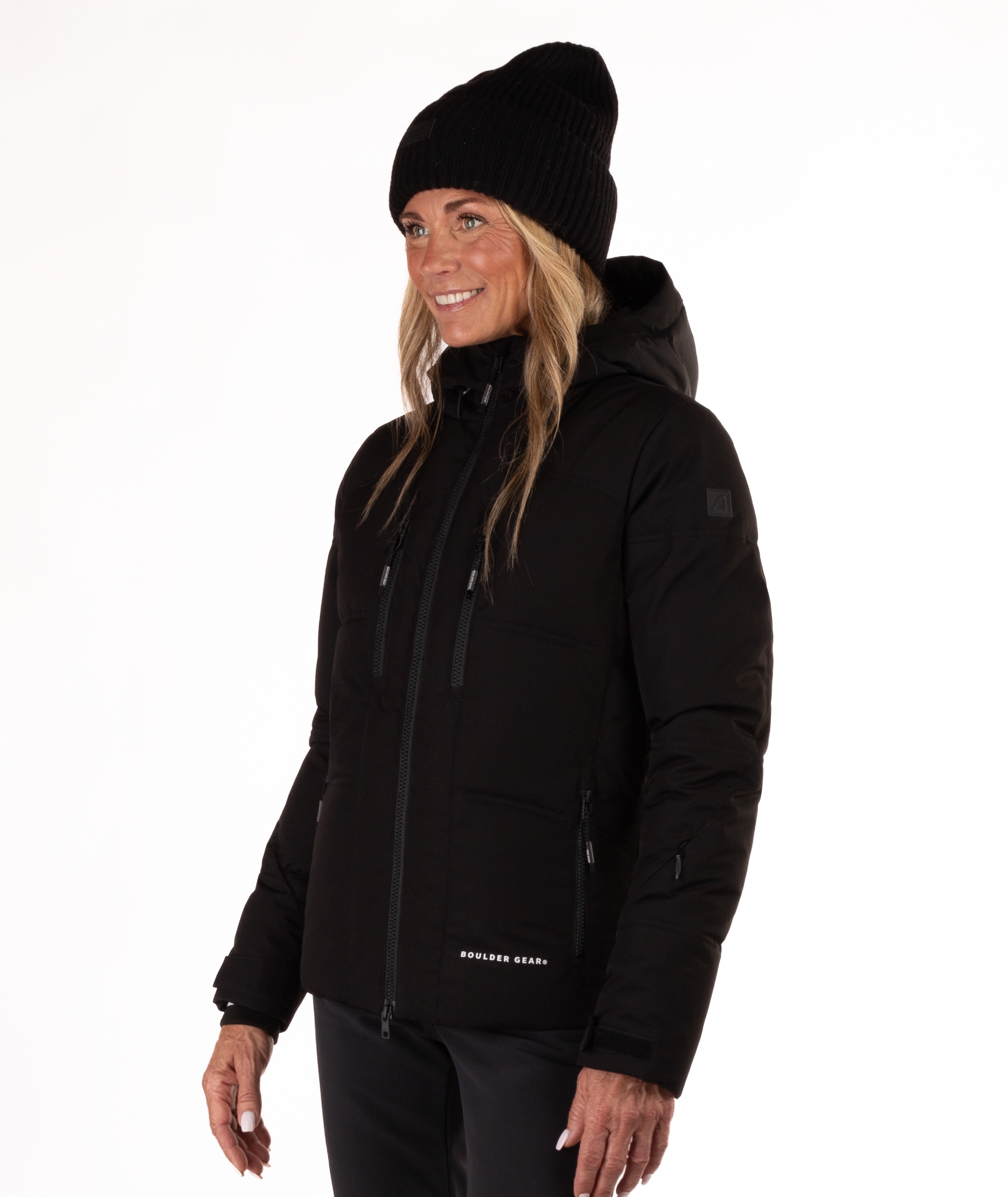 Woman wearing a black quilted winter jacket on a white background