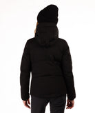 Woman wearing a black quilted winter jacket on a white background showing back of jacket and hood