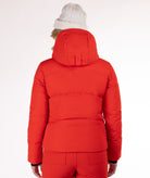 Woman wearing a red quilted winter jacket on a white background showing the back of the jacket